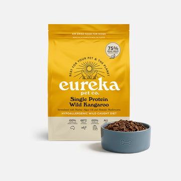 Bag of Eureka Pet Co Single Protein Wild Kangaroo air-dried dog food beside a blue bowl filled with the food.