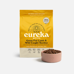 Bag of Eureka Pet Co Grass Fed Lamb & Wild Caught Sardine air-dried dog food beside a pink bowl filled with the food