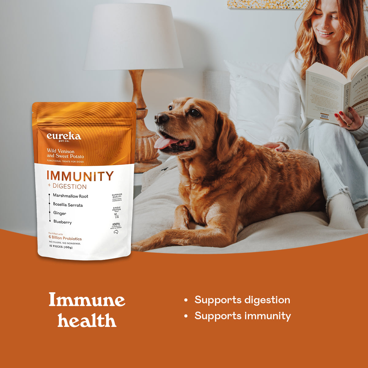 Golden retriever resting on a bed beside a woman reading, next to a bag of Eureka Pet Co Immunity & Digestion functional treat, supporting immune health.