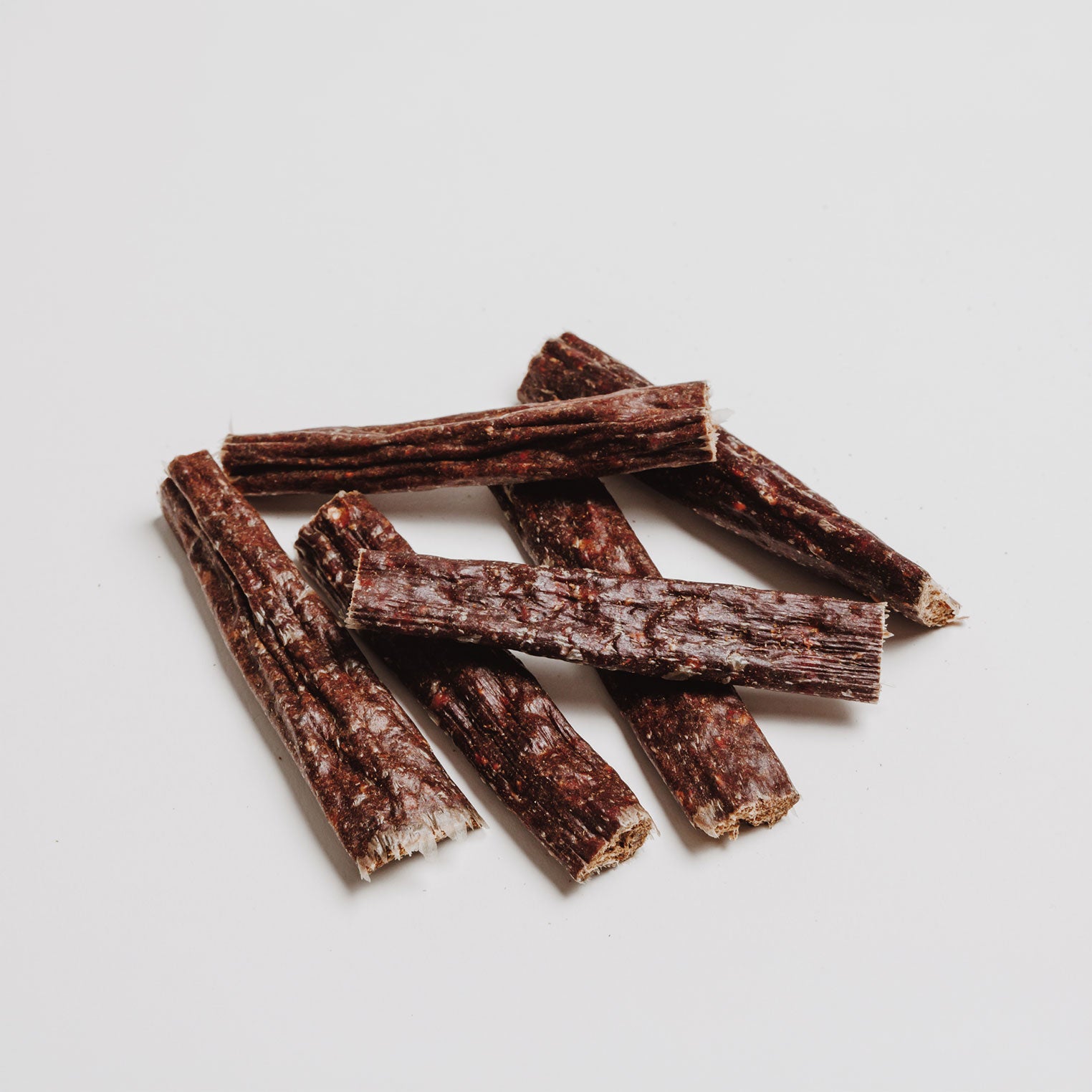 Close up of Eureka Breath Freshener natural dog treat sticks made with 75% wild venison, sweet potato, blueberry and mint for fresh dog breath